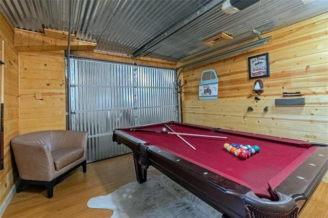 playroom with billiards, wood walls, and hardwood / wood-style floors