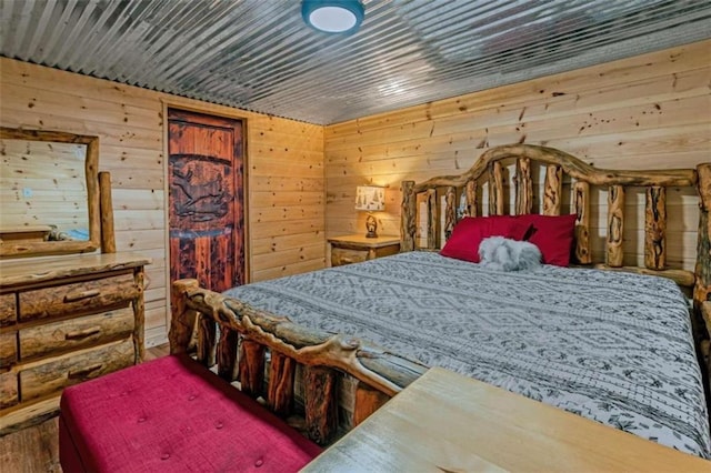 bedroom with wood walls