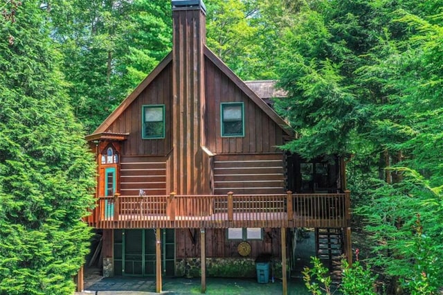 rear view of property featuring a deck