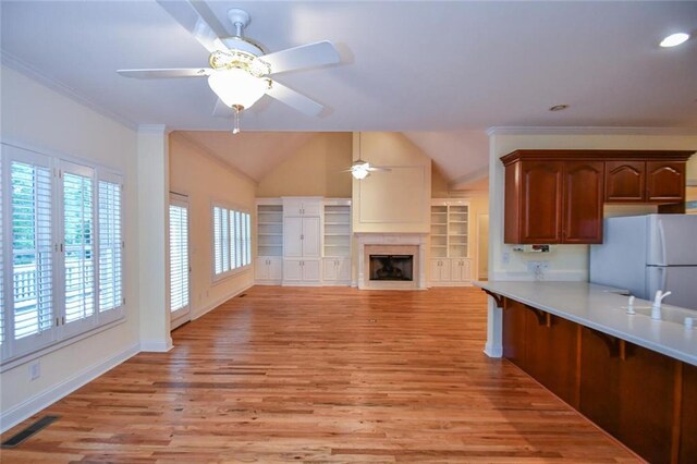 kitchen featuring ceiling fan, light hardwood / wood-style flooring, crown molding, and white refrigerator