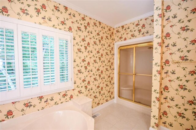 bathroom with tile patterned floors, crown molding, and independent shower and bath