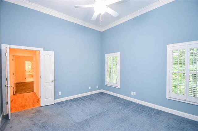 carpeted empty room featuring ceiling fan and ornamental molding