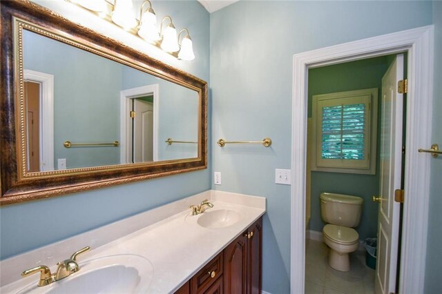 bathroom featuring tile patterned floors, vanity, and toilet