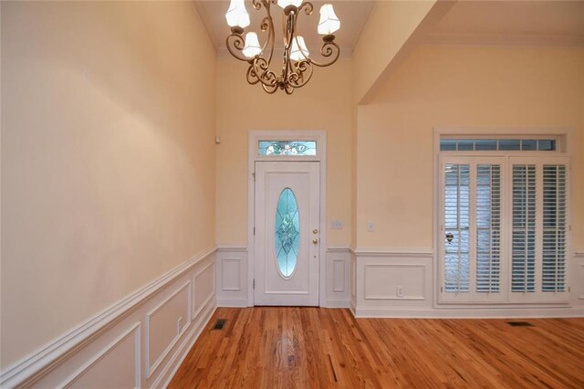 foyer entrance with a notable chandelier and light wood-type flooring