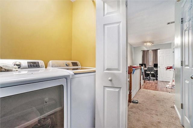 washroom with laundry area, independent washer and dryer, visible vents, and light colored carpet