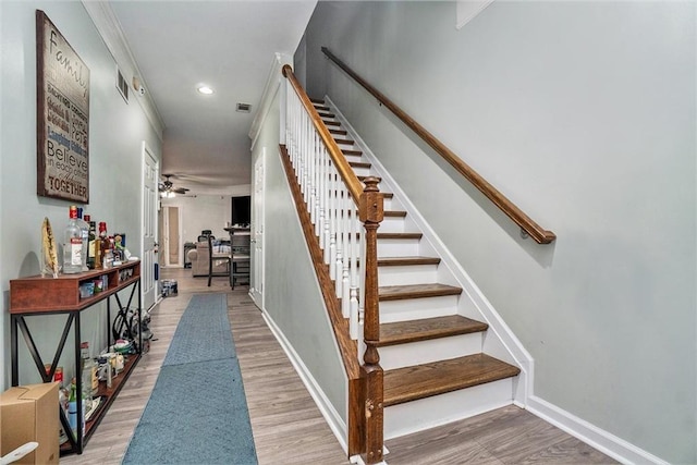 stairway with baseboards and wood finished floors