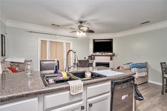 kitchen with a sink, visible vents, open floor plan, and dishwasher