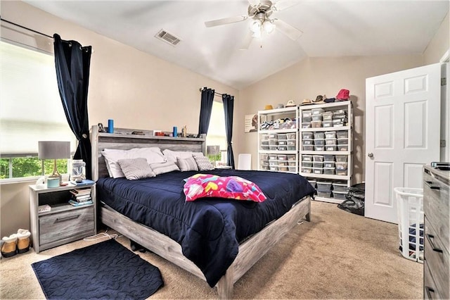 bedroom featuring light carpet, ceiling fan, visible vents, and lofted ceiling