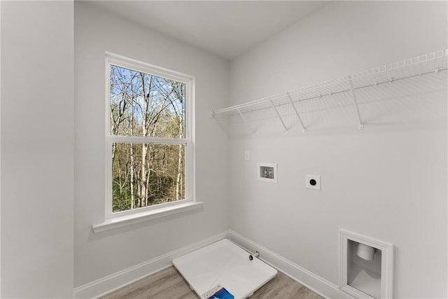 clothes washing area with light wood-type flooring, baseboards, electric dryer hookup, laundry area, and washer hookup