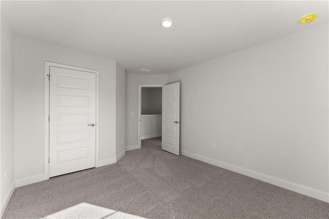 unfurnished bedroom featuring baseboards and carpet flooring
