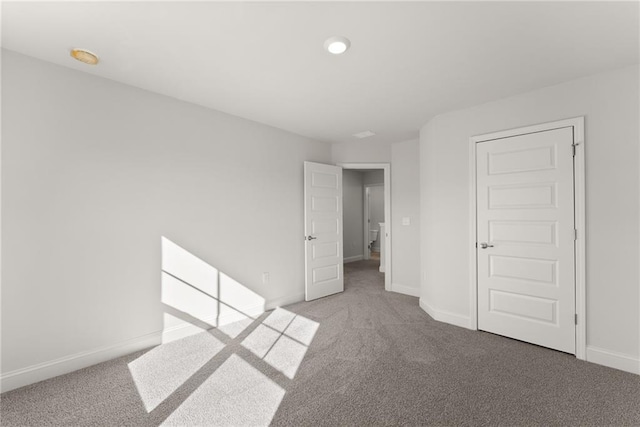 unfurnished bedroom featuring baseboards and carpet flooring