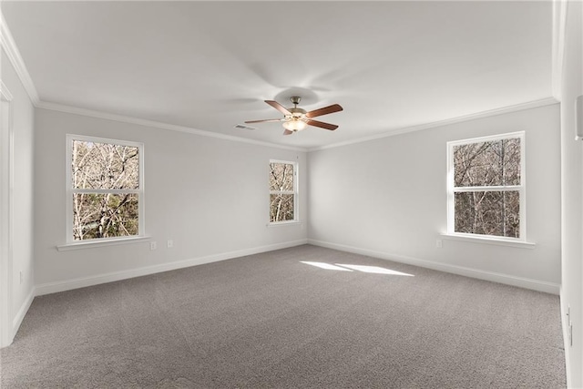 spare room featuring baseboards, carpet floors, ornamental molding, and ceiling fan