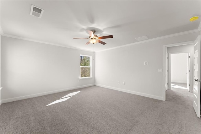 unfurnished room with ornamental molding, baseboards, ceiling fan, and visible vents