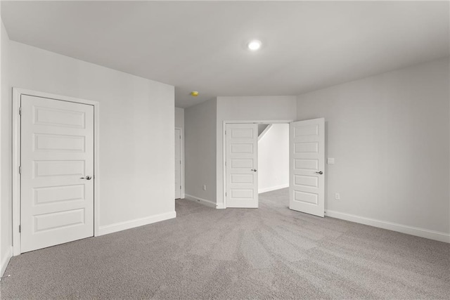 unfurnished bedroom with baseboards, carpet flooring, and recessed lighting