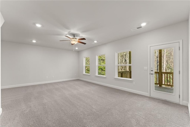 spare room featuring carpet floors, a ceiling fan, baseboards, visible vents, and recessed lighting