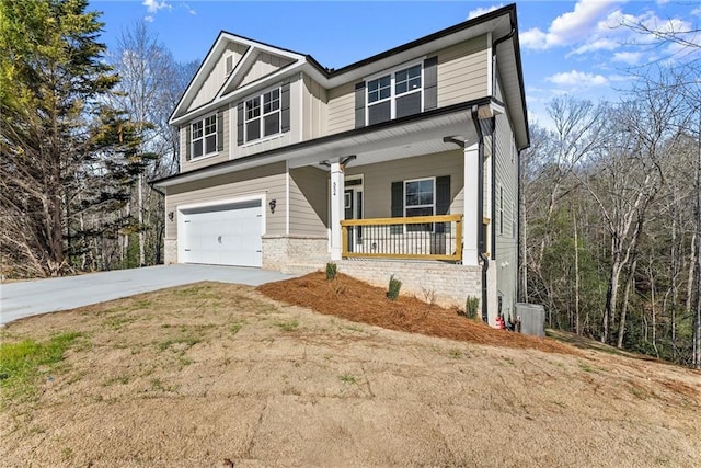 view of front facade with driveway, covered porch, central air condition unit, an attached garage, and board and batten siding