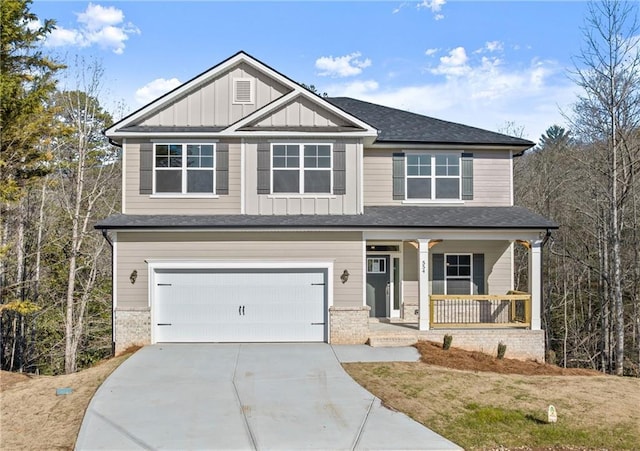 craftsman-style house with driveway, covered porch, board and batten siding, and an attached garage