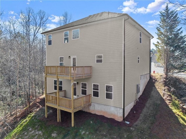rear view of property featuring a deck