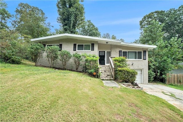 view of front of house featuring a front yard and a garage