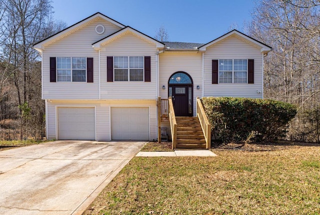 split foyer home featuring a garage and a front lawn