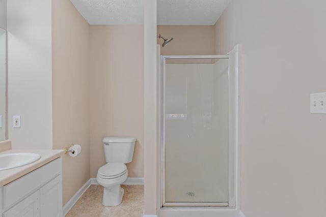 bathroom featuring tile patterned floors, vanity, toilet, and a shower with door