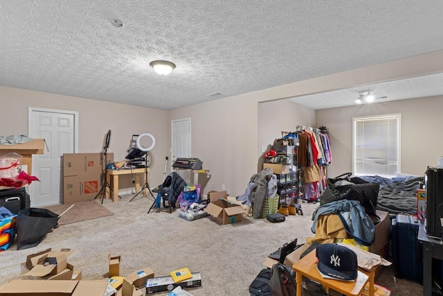 basement featuring a textured ceiling and carpet