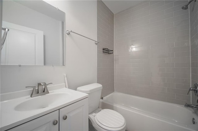 full bathroom featuring tiled shower / bath, vanity, and toilet