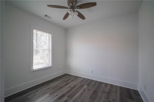 empty room featuring ceiling fan and dark hardwood / wood-style floors