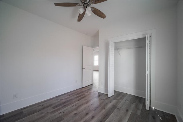 unfurnished bedroom featuring ceiling fan, dark hardwood / wood-style flooring, and a closet