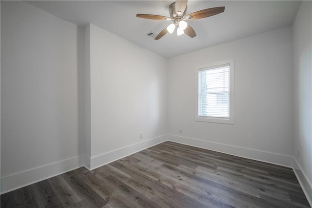 spare room featuring dark hardwood / wood-style floors and ceiling fan