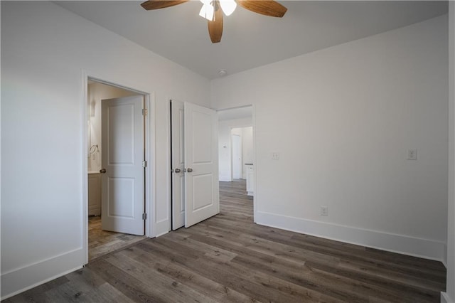 unfurnished bedroom with ceiling fan and dark hardwood / wood-style flooring