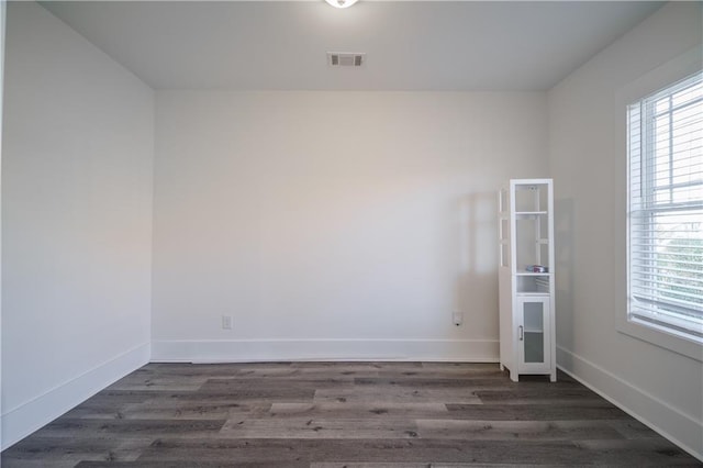 empty room featuring dark hardwood / wood-style flooring