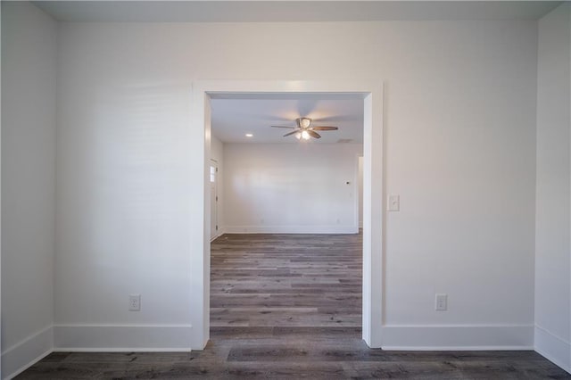 empty room with ceiling fan and dark hardwood / wood-style flooring