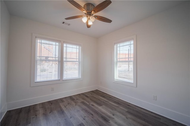 empty room with dark wood-type flooring and ceiling fan