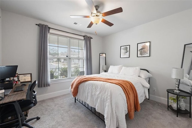 carpeted bedroom featuring baseboards, visible vents, and ceiling fan