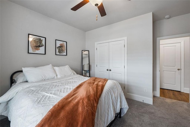 carpeted bedroom featuring a closet, baseboards, and ceiling fan