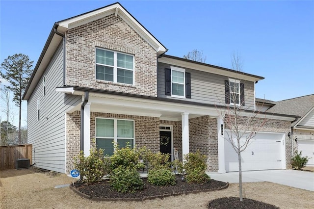 traditional home featuring brick siding, concrete driveway, and central AC