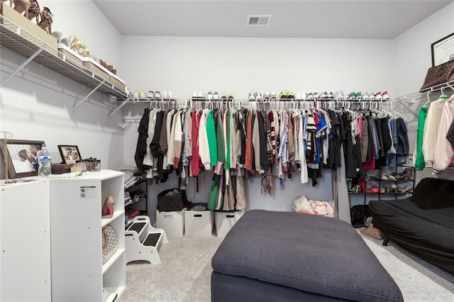 walk in closet featuring visible vents and carpet