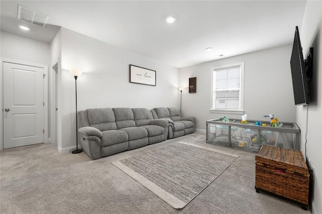 living area with visible vents, carpet floors, and baseboards