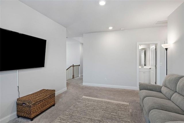 living area with recessed lighting, baseboards, and carpet flooring