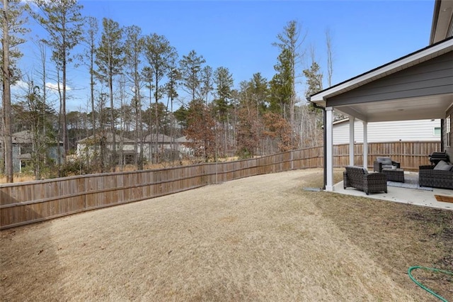 view of yard with outdoor lounge area, a patio area, and a fenced backyard