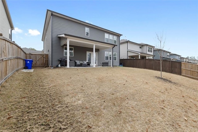 back of house with a patio and a fenced backyard