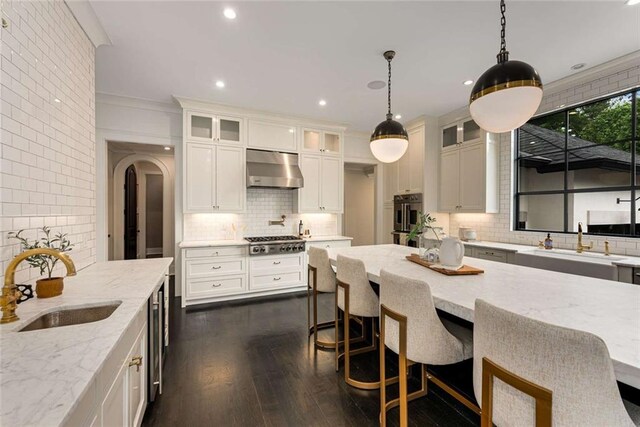 3773 Randall Rd SE, Atlanta, GA 30339 - kitchen featuring wall chimney range hood, stainless steel appliances, backsplash, a sink, and recessed lighting