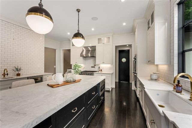 3773 Randall Rd SE, Atlanta, GA 30339 - kitchen with range hood, a sink, tasteful backsplash, dark cabinets, and white cabinetry