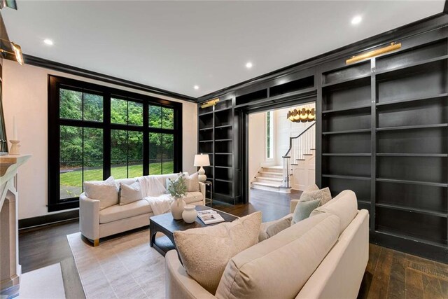 3773 Randall Rd SE, Atlanta, GA 30339 - living room featuring crown molding, stairs, plenty of natural light, built in shelves, and recessed lighting