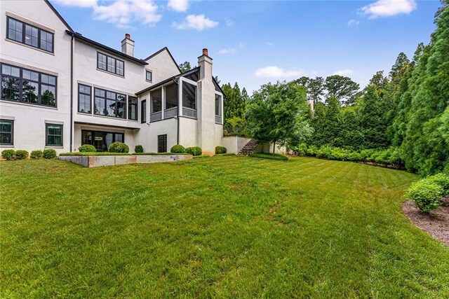 3773 Randall Rd SE, Atlanta, GA 30339 - view of green lawn with a sunroom and stairway