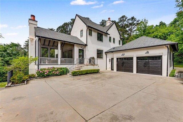 3773 Randall Rd SE, Atlanta, GA 30339 - view of front of property featuring a chimney, stucco siding, a porch, and roof with shingles