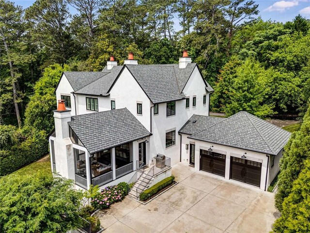 3773 Randall Rd SE, Atlanta, GA 30339 - view of front of house with a chimney, a garage, driveway, and stucco siding