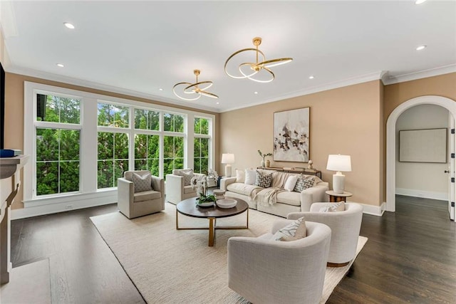 3773 Randall Rd SE, Atlanta, GA 30339 - living area with crown molding, a chandelier, baseboards, dark wood-type flooring, and arched walkways