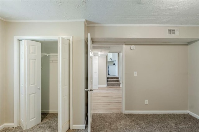 270 Hunt Ridge Dr, Stockbridge, GA 30281 - unfurnished room featuring light wood-style floors, a textured ceiling, baseboards, and crown molding